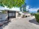 Tan house with white awnings, a black gate, and a landscaped yard at 16003 2Nd E St, Redington Beach, FL 33708