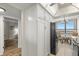 Eat-in kitchen with white cabinets, black appliances, and a view at 9415 Blind Pass Rd # 1103, St Pete Beach, FL 33706