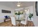 Dining area with glass table, four chairs and hardwood floors at 9415 Blind Pass Rd # 1103, St Pete Beach, FL 33706