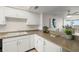 White kitchen cabinets and granite countertops at 9415 Blind Pass Rd # 1103, St Pete Beach, FL 33706