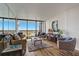 Living room with water view, comfy seating and hardwood floors at 9415 Blind Pass Rd # 1103, St Pete Beach, FL 33706