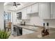 Modern kitchen with white cabinets, stainless steel appliances, and granite countertops at 9415 Blind Pass Rd # 1103, St Pete Beach, FL 33706