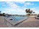 Inviting community pool with lounge chairs and waterfront views at 9415 Blind Pass Rd # 1103, St Pete Beach, FL 33706