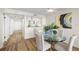 Open dining area with glass-top table and light hardwood floors at 9415 Blind Pass Rd # 1103, St Pete Beach, FL 33706
