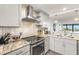 Modern kitchen with stainless steel appliances and granite countertops at 9495 Blind Pass Rd # 307, St Pete Beach, FL 33706
