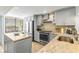 Modern kitchen with granite countertops and stainless steel appliances at 9495 Blind Pass Rd # 307, St Pete Beach, FL 33706