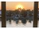 Sunset view over calm water with houses and palm trees at 12405 3Rd E St # 304, Treasure Island, FL 33706