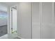 Hallway with neutral walls and white louvered doors at 12405 3Rd E St # 304, Treasure Island, FL 33706