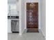 View of kitchen and entryway with dark wood door at 12405 3Rd E St # 304, Treasure Island, FL 33706