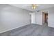 Spacious bedroom with grey carpet and ceiling fan at 12405 3Rd E St # 304, Treasure Island, FL 33706