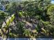 Empty lot for sale, surrounded by lush trees and foliage at 761 Soundview Dr, Palm Harbor, FL 34683