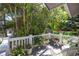Cozy balcony filled with lush greenery and white wicker furniture, offering a serene view at 761 Soundview Dr, Palm Harbor, FL 34683