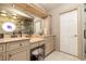 Bathroom featuring double sinks, granite countertops and custom lighting at 761 Soundview Dr, Palm Harbor, FL 34683