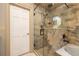 Bathroom showcasing stone-tiled shower with glass door and soaking tub at 761 Soundview Dr, Palm Harbor, FL 34683