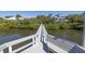 Long dock leading to a waterfront home with seating at 761 Soundview Dr, Palm Harbor, FL 34683