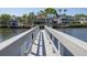 View of a wooden dock extending into the water with waterfront homes in the background at 761 Soundview Dr, Palm Harbor, FL 34683