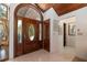 Inviting foyer showcasing a decorative wood door and tile flooring at 761 Soundview Dr, Palm Harbor, FL 34683
