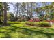 White gazebo with seating area in a lush, landscaped garden at 761 Soundview Dr, Palm Harbor, FL 34683