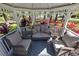 Relaxing gazebo interior with wicker furniture and pillows at 761 Soundview Dr, Palm Harbor, FL 34683