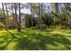Two-story gray house with balcony, partially hidden by trees at 761 Soundview Dr, Palm Harbor, FL 34683