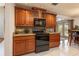 Traditional kitchen featuring wood cabinets, granite countertops and modern appliances at 761 Soundview Dr, Palm Harbor, FL 34683