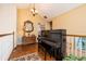 Bright landing area with hardwood floors, piano, and ornate mirror at 761 Soundview Dr, Palm Harbor, FL 34683