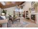 Spacious living room with a wood ceiling, fireplace, and views into the kitchen and dining area at 761 Soundview Dr, Palm Harbor, FL 34683