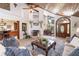 Warm living room with a fireplace, wood ceiling, and open access to dining and kitchen areas at 761 Soundview Dr, Palm Harbor, FL 34683