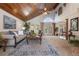 Bright living room featuring a vaulted wood ceiling, large windows, and neutral furnishings at 761 Soundview Dr, Palm Harbor, FL 34683
