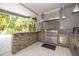 Stainless steel appliances and stone countertops highlight this outdoor kitchen at 761 Soundview Dr, Palm Harbor, FL 34683