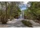 Charming pathway to a private dock, nestled in tropical landscape at 761 Soundview Dr, Palm Harbor, FL 34683