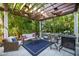 Relaxing patio with pergola, wicker furniture, and a charming sitting area at 761 Soundview Dr, Palm Harbor, FL 34683