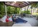 Lush patio with pergola, wicker furniture and a small bar at 761 Soundview Dr, Palm Harbor, FL 34683