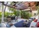 Relaxing outdoor patio with pergola, comfortable seating, and a bar at 761 Soundview Dr, Palm Harbor, FL 34683
