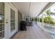 Outdoor patio with a grilling area and dining set that overlooks manicured landscape at 761 Soundview Dr, Palm Harbor, FL 34683
