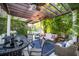 Covered patio with pergola, comfortable seating, and outdoor bar at 761 Soundview Dr, Palm Harbor, FL 34683