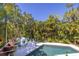 Inviting pool area with lush tropical landscaping at 761 Soundview Dr, Palm Harbor, FL 34683