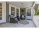 Relaxing covered porch with wicker seating and tiled floor at 761 Soundview Dr, Palm Harbor, FL 34683