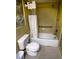 Bathroom with shower/tub combo, toilet and yellow tile at 2101 Sunset Point Rd # 1001, Clearwater, FL 33765