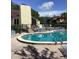 Community pool with lounge chairs and surrounding patio at 2101 Sunset Point Rd # 1001, Clearwater, FL 33765