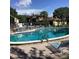 Community pool with lounge chairs and surrounding patio at 2101 Sunset Point Rd # 1001, Clearwater, FL 33765