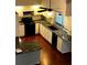 Bright kitchen featuring granite countertops and ample cabinetry at 2101 Sunset Point Rd # 1001, Clearwater, FL 33765