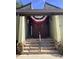 Building exterior with steps leading to entrance, featuring a festive decoration at 2101 Sunset Point Rd # 1001, Clearwater, FL 33765