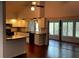 Kitchen with granite counters, white cabinets and view into sunroom at 2101 Sunset Point Rd # 1001, Clearwater, FL 33765
