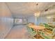 Dining room with a chandelier and view into living room at 2431 Canadian Way # 9, Clearwater, FL 33763