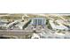 Aerial view of a multi-unit building near the beach with parking and a pool at 11605 1St E St # 6, Treasure Island, FL 33706