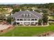 Spacious clubhouse featuring a wraparound porch and beautiful landscaping, perfect for community gatherings at 4780 Majestic Hills Loop, Brooksville, FL 34601