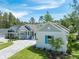 Exterior front view of the house and surrounding neighborhood street, lawn, and driveway at 4780 Majestic Hills Loop, Brooksville, FL 34601