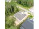 New construction home with gray roof, nestled in a wooded neighborhood at 4780 Majestic Hills Loop, Brooksville, FL 34601