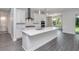 Modern kitchen with white cabinets, quartz countertops, and island at 4780 Majestic Hills Loop, Brooksville, FL 34601